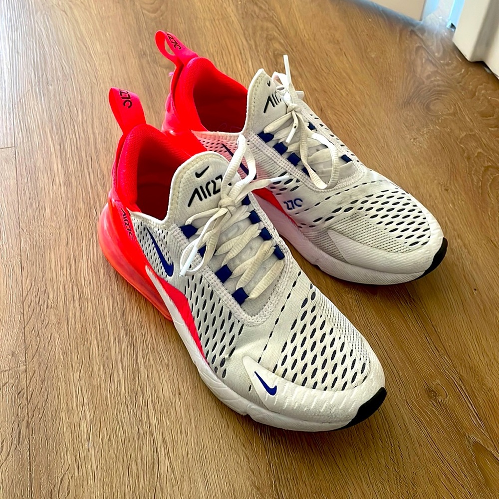 Nike white sneaker with pink back and blue detailing.